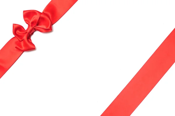 Red ribbon with bow on white — Stock Photo, Image