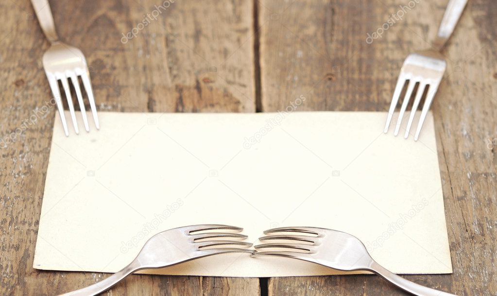 Silver forks on a old paper