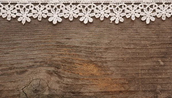 Wooden background with white lace frame — Stok fotoğraf