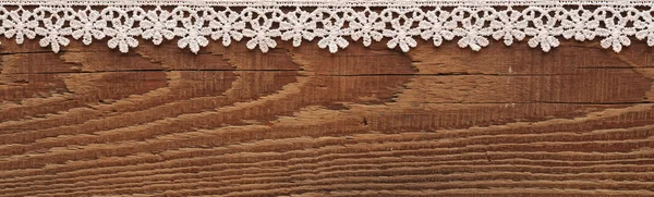 Wooden background with white lace frame — Stok fotoğraf