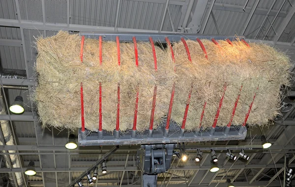 A tractor stacking large bales hay — Stock Photo, Image
