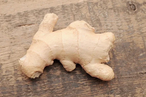 stock image Root ginger on wooden background