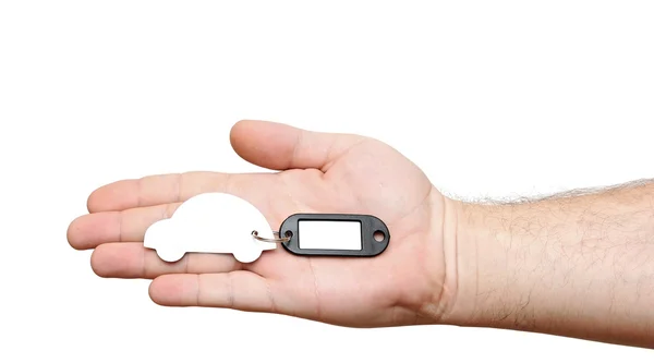 Human hands holding model car with blank tag isolated on white b — Stock Photo, Image