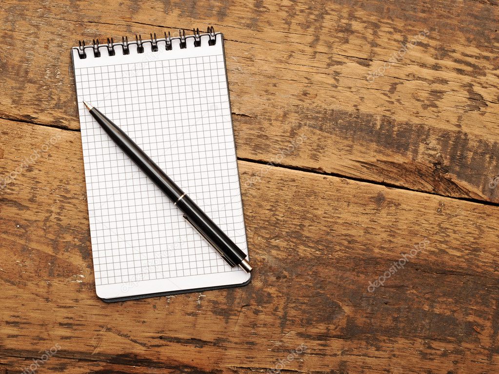 Blank notepad with pen on wood table