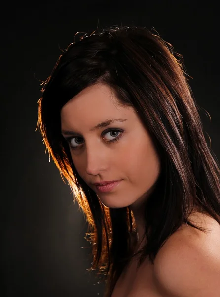 Fashion brunette girl posing on dark background — Stock Photo, Image