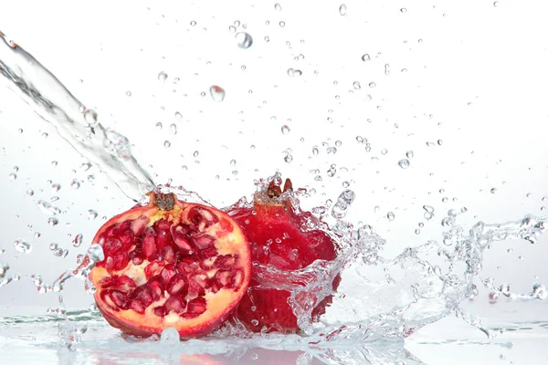 Juicy pomegranate with splashing water — Stock Photo, Image