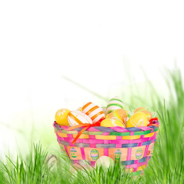 Colorful painted easter eggs in basket — Stock Photo, Image