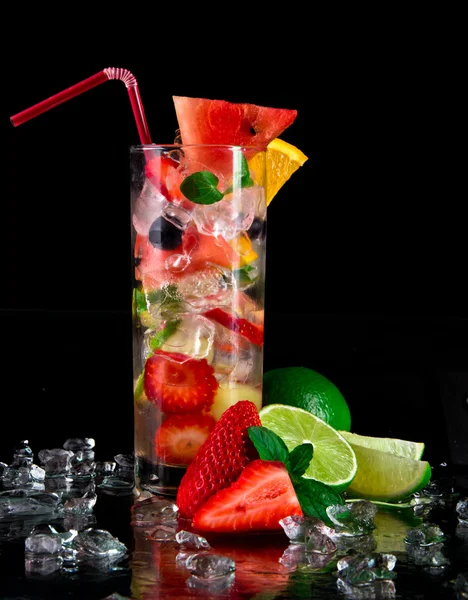 Fruit cocktail over black background — Stock Photo, Image
