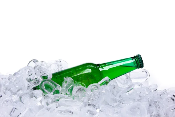 Beer bottle in ice cubes over white background — Stock Photo, Image