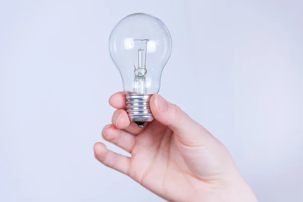 Hand holds the electrical lamp — Stock Photo, Image