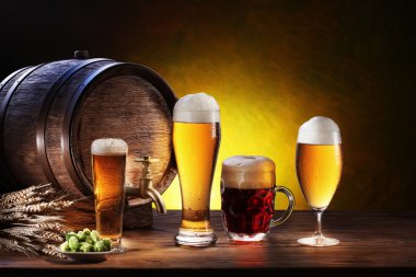 Beer barrel with beer glasses on a wooden table. clipart