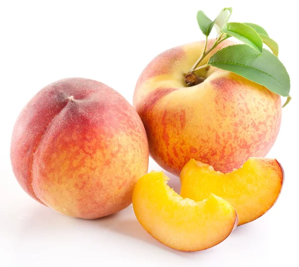 Ripe peach fruit with leaves and slises Royalty Free Stock Images