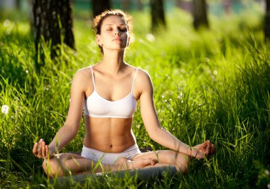 Practicing of yoga outdoors. clipart