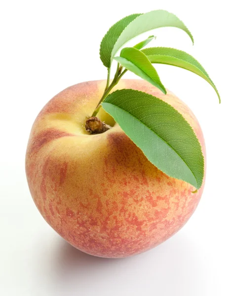 Спелый персик с листьями — стоковое фото