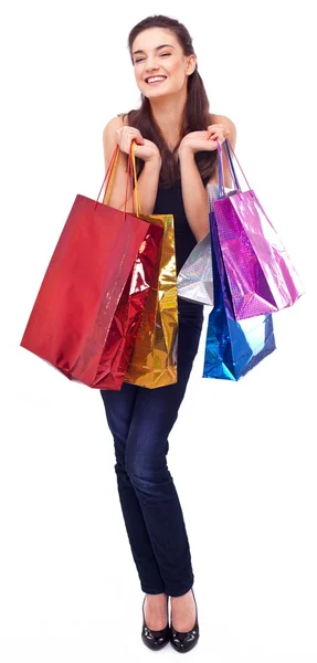 Menina sorridente com sacos de compras. Isolado sobre um fundo branco . — Fotografia de Stock