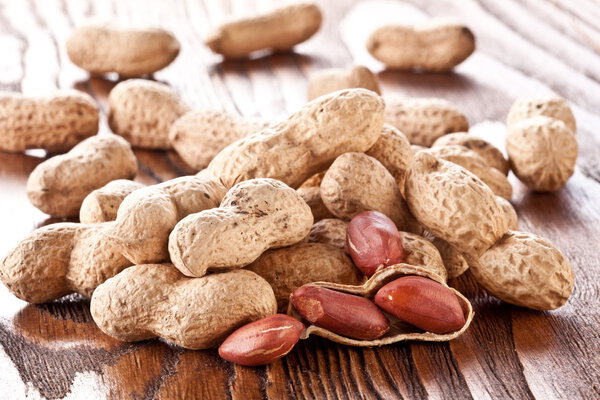 Peanuts on a wooden table.