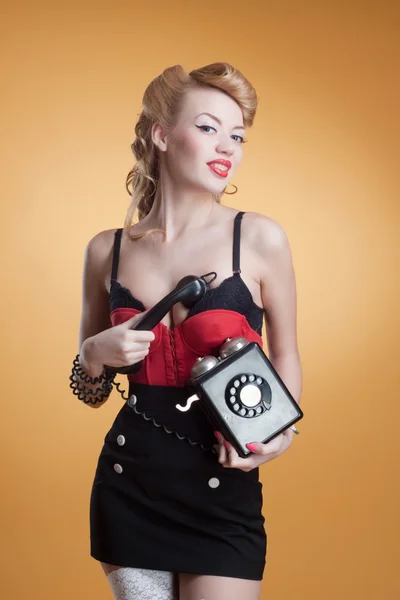 Beautiful young girl with a vintage telephone survey in retro style — Stock Photo, Image