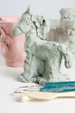 Modelling a clay horse clipart