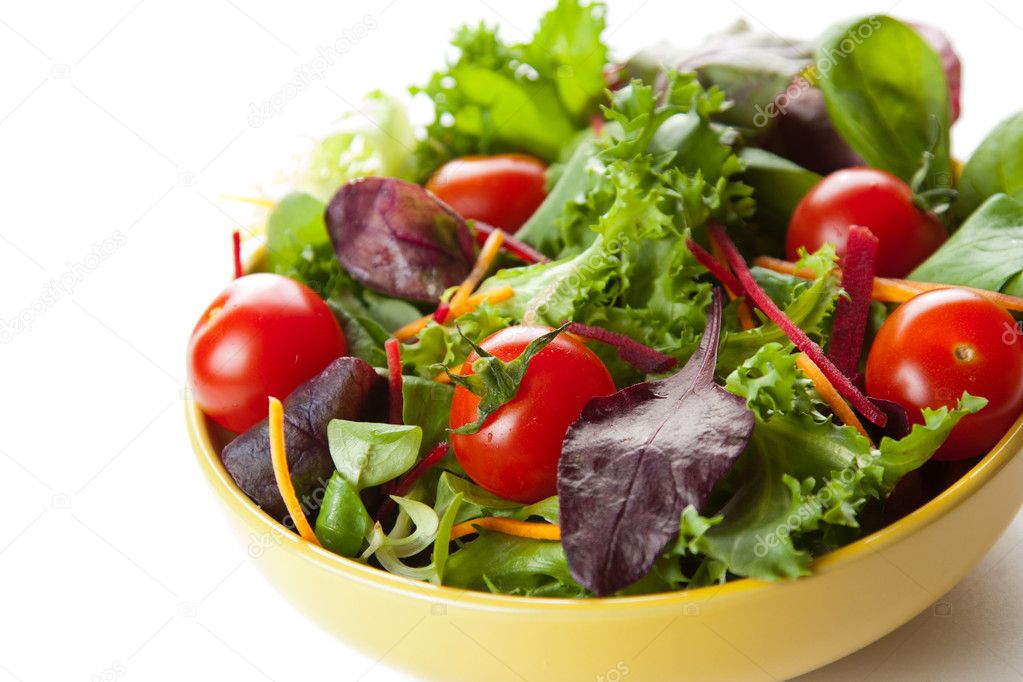 Bowl of fresh green salad with tomatoes