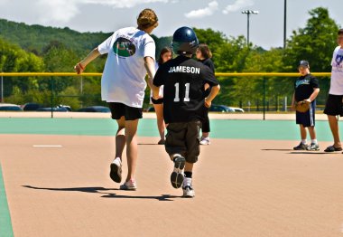 Miracle League Softball Player and Volunteer clipart