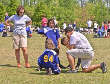 Couple Coaching Girls Soccer clipart