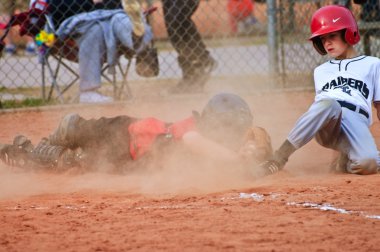 Youth Baseball Player Sliding Into Home clipart