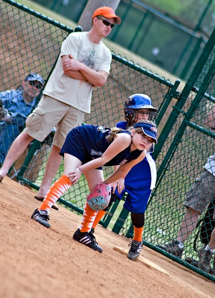 Girl 's Softball Runner on First — стоковое фото