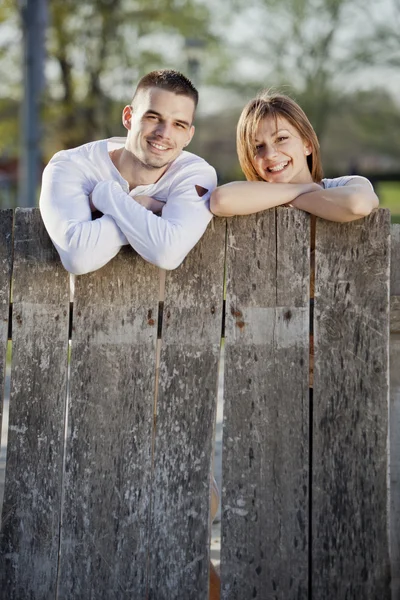 Couple by the fence — Stock Photo, Image