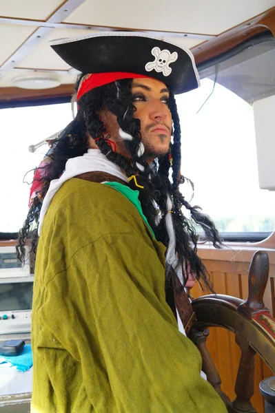 stock image Actor in the guise of Jack Sparrow in the wheelhouse of a sailing ship