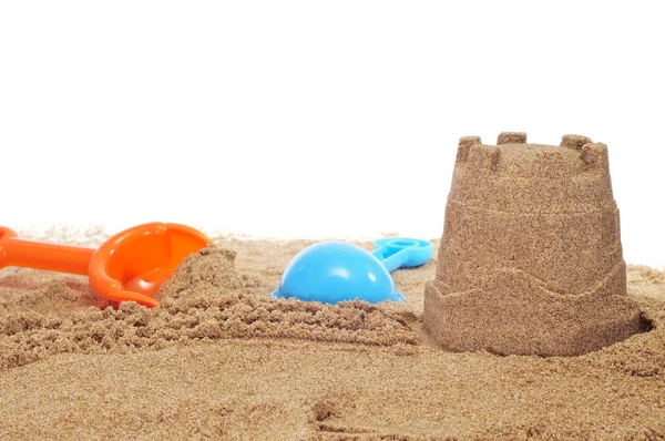 Sandcastle and beach shovels — Stock Photo, Image