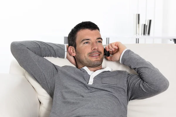 On the phone at home on sofa — Stock Photo, Image