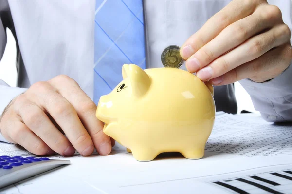 Dropping coin to piggybank — Stock Photo, Image
