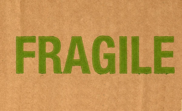 Fragile written on corrugated cardboard packet — Stock Photo, Image