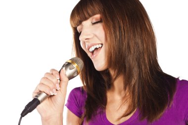 Happy young woman singing with microphone clipart