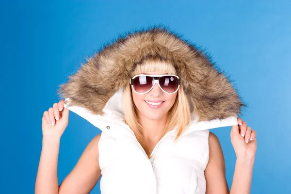 Woman in the hood on a blue background — Stock Photo, Image