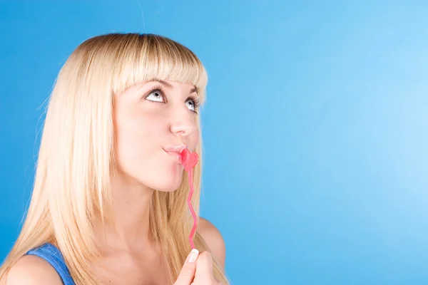Portrait of sexy blond woman sucking her candy, love heart — Stock Photo, Image