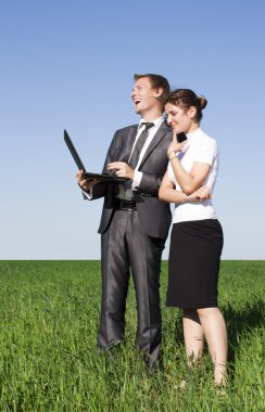 Two successful workers in the street with a laptop clipart