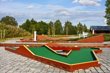 Mini golf ready to play. Outdoors scene clipart