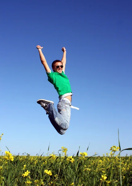 Young men jump in the meadow — Stock Photo, Image
