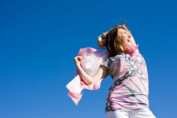 Happy brunette playing with a scarf in the summer — Stock Photo, Image