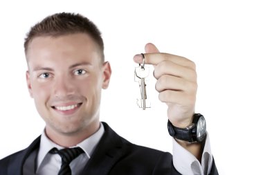 Young businessman holding a key clipart