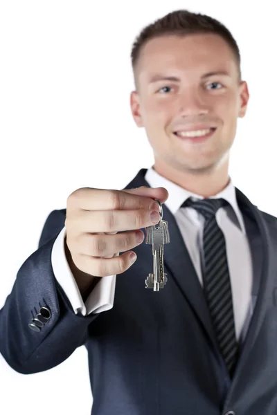 Young businessman holding a key — Stock Photo, Image