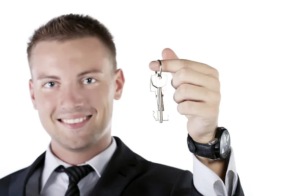 Young businessman holding a key — Stock Photo, Image