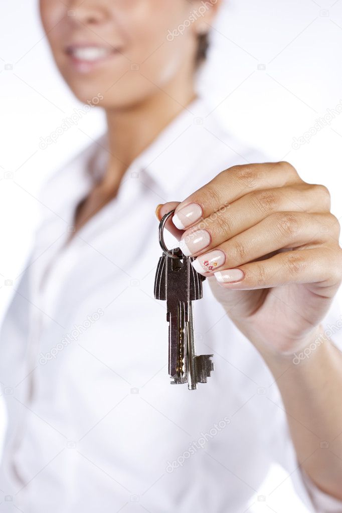 Hand holding two house keys on a key chain