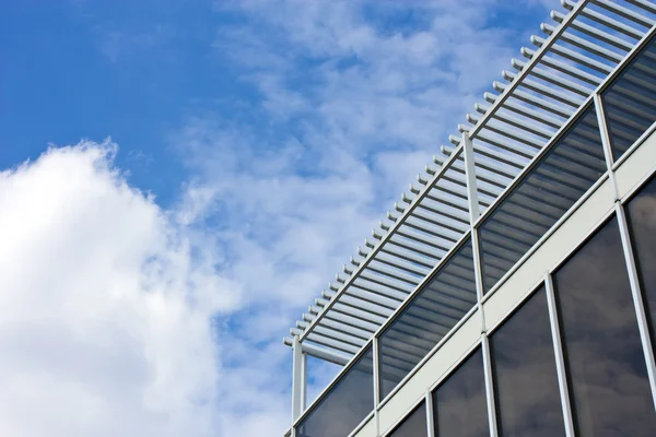 stock image Modern office house. blue glass on a background sky