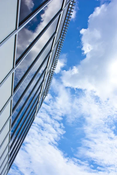 stock image Modern office house. blue glass on a background sky