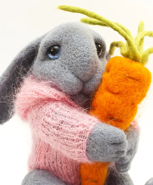 Игрушечный кролик с морковью — стоковое фото
