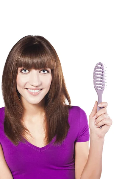 Attractive smiling woman brushing her hear — Stock Photo, Image
