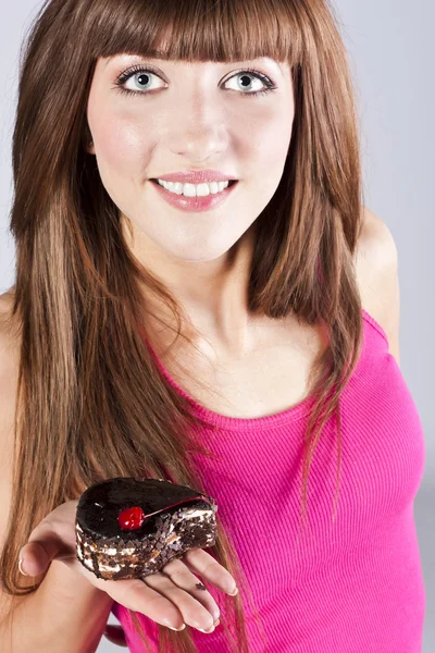 Beautiful brunette woman with a cake — Stock Photo, Image