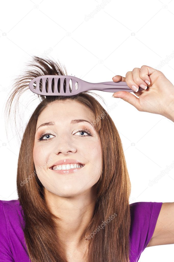 Attractive smiling woman brushing her hear